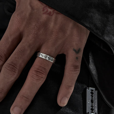 It's a classic for a reason. Celestial hearts combine with their S-logo in their new imprint band. This narrow band style ring is made from sterling silver with dark oxidised detailing.